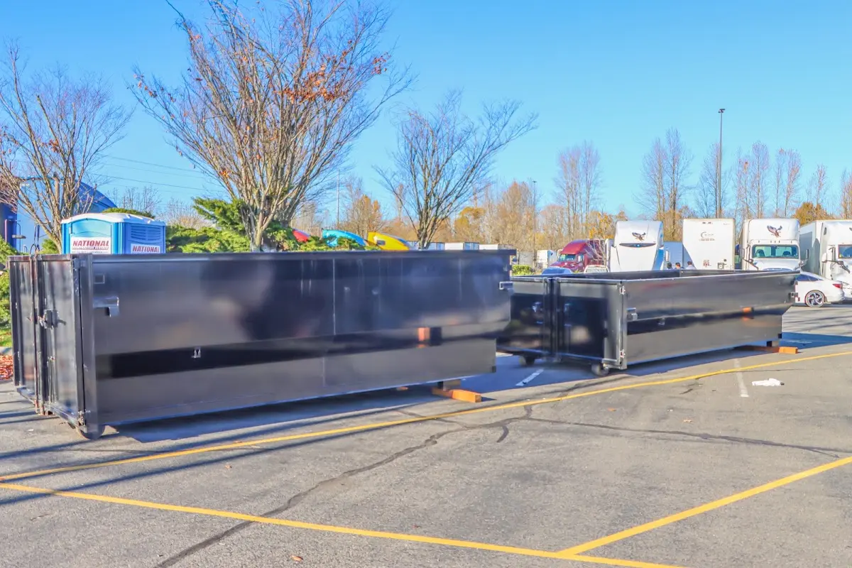 Professional dumpster rental service with roll-off container on residential driveway in Marathon
